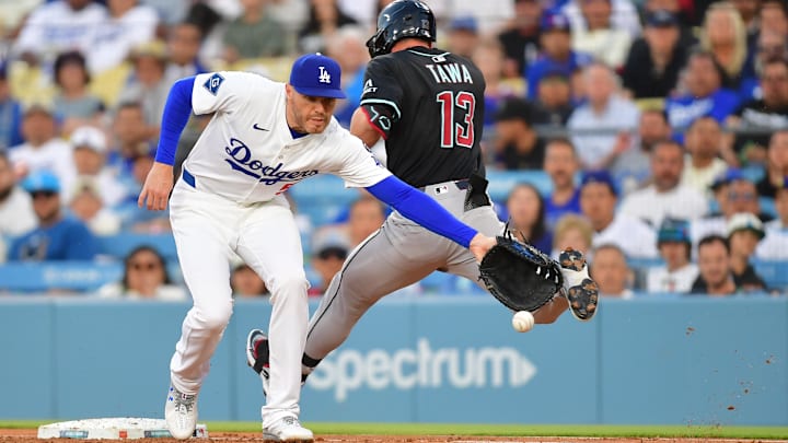 May 19, 2025; Los Angeles, California, USA; Arizona Diamondbacks second base Tim Tawa (13) is safe at first against Los Angeles Dodgers first base Freddie Freeman (5) in the second inning at Dodger Stadium. Mandatory Credit: Gary A. Vasquez-Imagn Images May 19, 2025; Los Angeles, California, USA; Arizona Diamondbacks second base Tim Tawa (13) is safe at first against Los Angeles Dodgers first base Freddie Freeman (5) in the second inning at Dodger Stadium. Mandatory Credit: Gary A. Vasquez-Imagn Images
