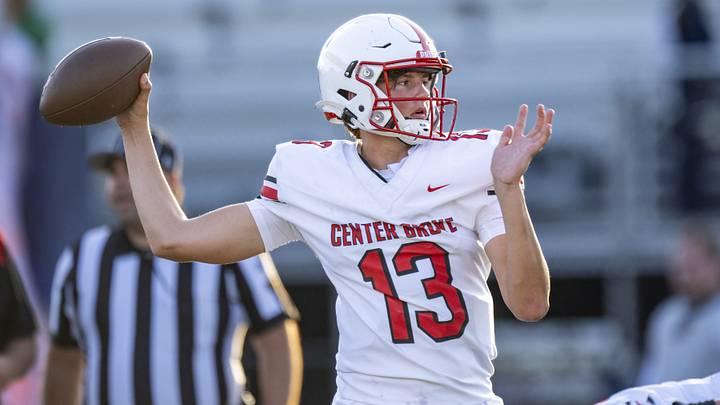 Center Grove High School freshman Oscar Sloan (13) warms up on the field.