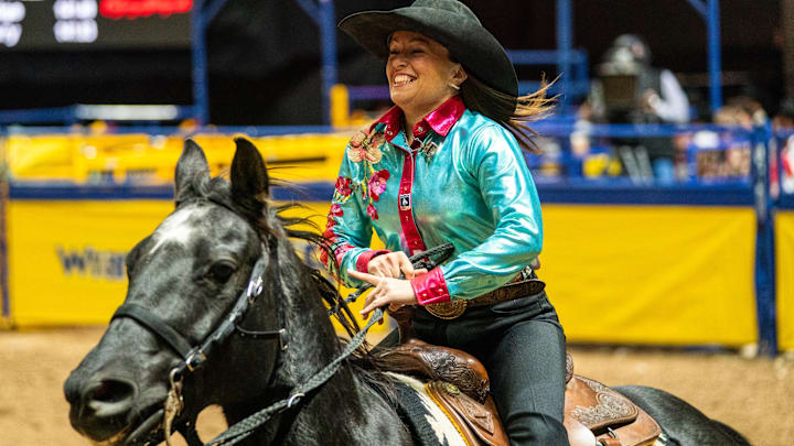 Julie Plourde taking a victory lap at the 2025 NFR inside the Thomas & Mack arena. 