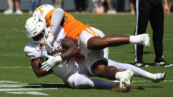 Sep 26, 2026; Knoxville, Tennessee, USA;  Tennessee Volunteers defensive tackle Xavier Gilliam (2) tackles Texas Longhorns running back Derrek Cooper (5) during the first half at Neyland Stadium.  Mandatory Credit: Randy Sartin-Imagn Images