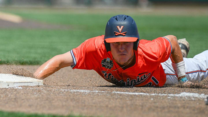 Virginia Cavaliers third baseman Eric Becker (21) slides back into first base against the North Carolina Tar Heels during the fourth inning at Charles Schwab Filed Omaha. Virginia Cavaliers third baseman Eric Becker (21) slides back into first base against the North Carolina Tar Heels during the fourth inning at Charles Schwab Filed Omaha.