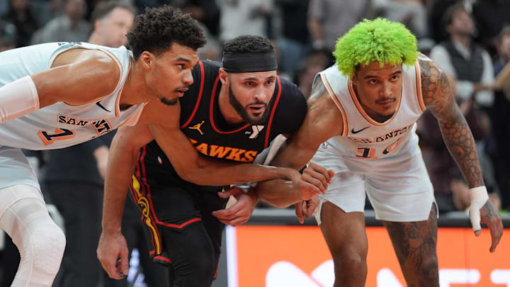 Dec 19, 2024; San Antonio, Texas, USA;  San Antonio Spurs center Victor Wembanyama (1) and forward Jeremy Sochan (10) surround Atlanta Hawks forward Larry Nance Jr. (22) in the second half at Frost Bank Center. Mandatory Credit: Daniel Dunn-Imagn Images