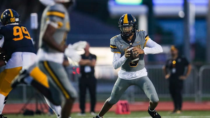 American Heritage Patriots quarterback Dia Bell (3) scrambles in the backfield during the first quarter of a game against the Naples Golden Eagles at Staver Field in Naples on Friday, Sept. 13, 2024.