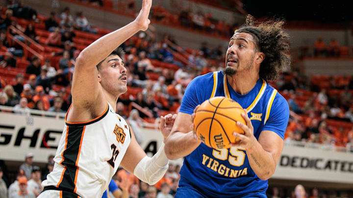 Feb 24, 2026; Stillwater, Oklahoma, USA; West Virginia Mountaineers center Harlan Obioha (55) drives around Oklahoma State Cowboys forward Parsa Fallah (22) during the second half at Gallagher-Iba Arena. Mandatory Credit: William Purnell-Imagn Images Feb 24, 2026; Stillwater, Oklahoma, USA; West Virginia Mountaineers center Harlan Obioha (55) drives around Oklahoma State Cowboys forward Parsa Fallah (22) during the second half at Gallagher-Iba Arena. Mandatory Credit: William Purnell-Imagn Images