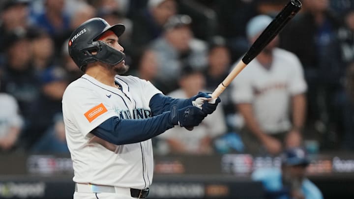 Oct 16, 2025; Seattle, Washington, USA; Seattle Mariners first baseman Josh Naylor (12) hits a solo home run against the Toronto Blue Jays in the second inning during game four of the ALCS round for the 2025 MLB playoffs at T-Mobile Park. Mandatory Credit: Stephen Brashear-Imagn Images