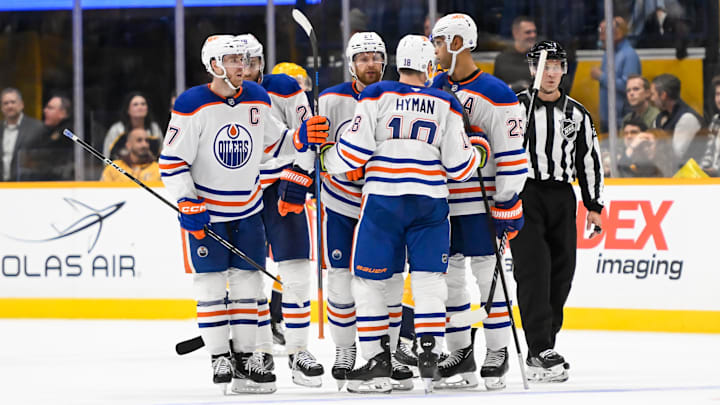 Oct 17, 2024; Nashville, Tennessee, USA;  Edmonton Oilers defenseman Brett Kulak (27) celebrates his goal with his teammates  against the Nashville Predators during the third period at Bridgestone Arena. Mandatory Credit: Steve Roberts-Imagn Images