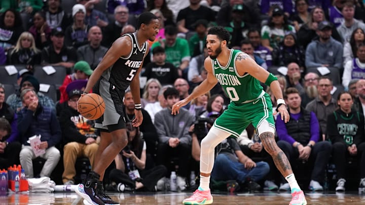 Mar 21, 2023; Sacramento, California, USA; Sacramento Kings guard De'Aaron Fox (5) is defended by Boston Celtics forward Jayson Tatum (0) in the second quarter at the Golden 1 Center. Mandatory Credit: Cary Edmondson-Imagn Images
