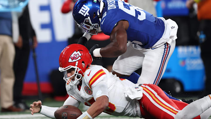 Sep 21, 2025; East Rutherford, New Jersey, USA; Kansas City Chiefs quarterback Patrick Mahomes (15) recovers a fumble against New York Giants inside linebacker Bobby Okereke (58) in the second quarter at MetLife Stadium. Mandatory Credit: Vincent Carchietta-Imagn Images