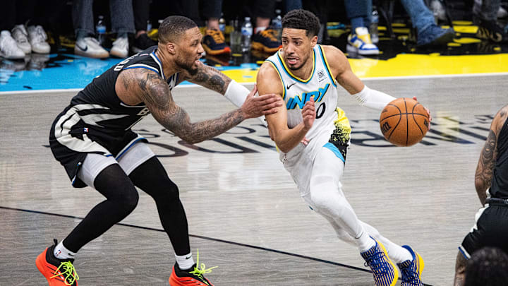 Apr 22, 2025; Indianapolis, Indiana, USA: Indiana Pacers guard Tyrese Haliburton (0) dribbles the ball while Milwaukee Bucks guard Damian Lillard (0) defends during game two of first round for the 2024 NBA Playoffs at Gainbridge Fieldhouse. Mandatory Credit: Trevor Ruszkowski-Imagn Images