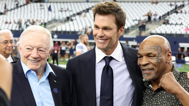 Cowboys owner Jerry Jones, Fox Sports commentator Tom Brady, and boxer Mike Tyson pose for a photo
