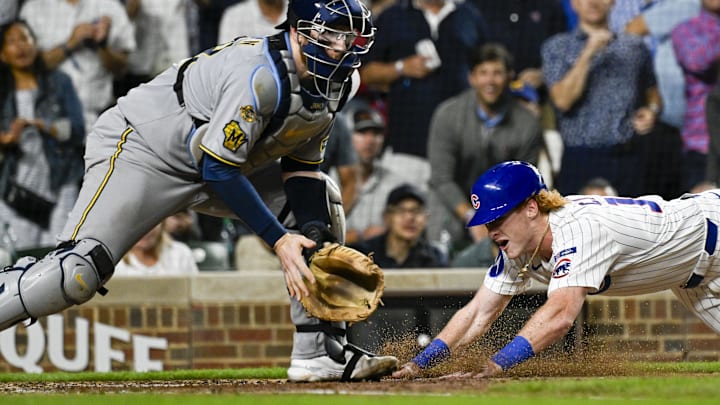 Aug 19, 2025; Chicago, Illinois, USA; Chicago Cubs outfielder Owen Caissie (19) scores past Milwaukee Brewers catcher Danny  Jansen (33) during the second inning at Wrigley Field. Mandatory Credit: Matt Marton-Imagn Images