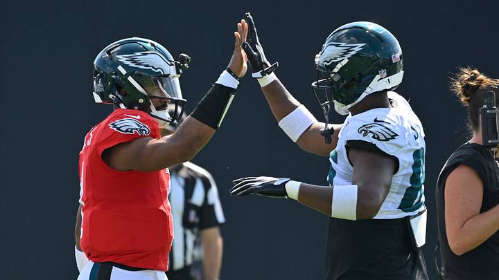 Eagles quarterback Jalen Hurts (left) high-fives tight end Stone Smartt (85) on Wednesday at Gillette Stadium. Eagles quarterback Jalen Hurts (left) high-fives tight end Stone Smartt (85) on Wednesday at Gillette Stadium.