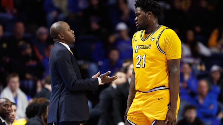 Jan 14, 2025; Gainesville, Florida, USA; Missouri Tigers head coach Dennis Gates talks with Missouri Tigers center Peyton Marshall (21) against the Florida Gators during the first half at Exactech Arena at the Stephen C. O'Connell Center. Mandatory Credit: Matt Pendleton-Imagn Images