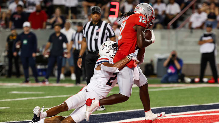 Aug 31, 2024; Tucson, Arizona, USA; Arizona Wildcats defensive back Treydan Stokes (2) fails to tackle New Mexico Lobos wide receiver Caleb Medford (12) as he makes a touchdown during second quarter at Arizona Stadium. Aug 31, 2024; Tucson, Arizona, USA; Arizona Wildcats defensive back Treydan Stokes (2) fails to tackle New Mexico Lobos wide receiver Caleb Medford (12) as he makes a touchdown during second quarter at Arizona Stadium.