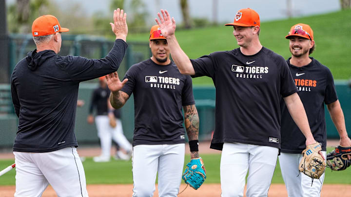 From left, Detroit Tigers manager A.J. Hinch high-fivesshortstop Javier Báez, infielder Trey Sweeney and infielder Zach McKinstry after a workout during spring training at Joker Marchant Stadium in Lakeland, Fla. on Thursday, Feb. 20, 2025.