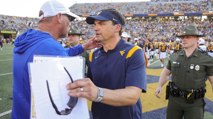 Sep 21, 2024; Morgantown, West Virginia, USA; West Virginia Mountaineers head coach Neal Brown speaks with Kansas Jayhawks head coach Lance Leipold after the game at Mountaineer Field at Milan Puskar Stadium. Mandatory Credit: Ben Queen-Imagn Images