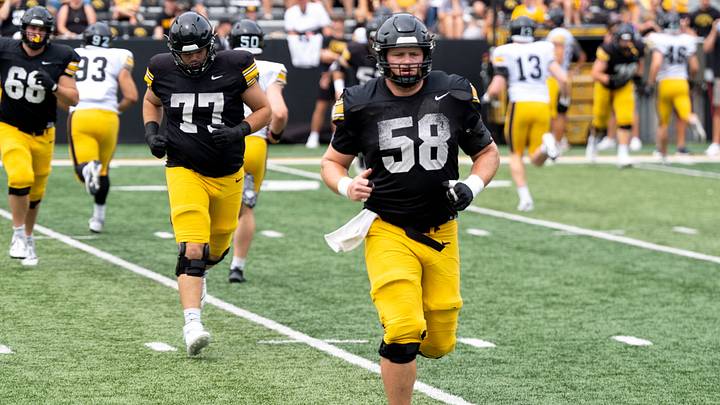 Iowa offensive lineman Kade Pieper (58) warms up Aug. 15, 2026 during the Kids Day at Kinnick open practice at Kinnick Stadium in Iowa City, Iowa.