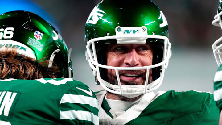 New York Jets quarterback Aaron Rodgers (8) smiles after throwing his fourth touchdown pass of the day, Sunday January 5, 2025, in East Rutherford.