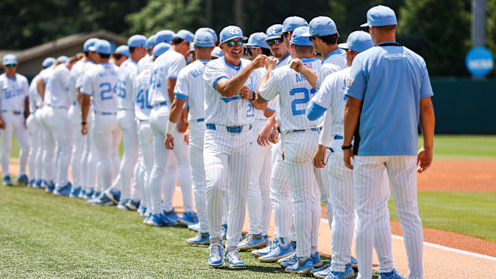 Jun 8, 2025; Chapel Hill, NC, USA;  North Carolina Head Coach Scott Forbes high fives the ream before the first inning of the Super Regionals game against Arizona in Chapel Hill, North Carolina. Mandatory Credit: Jaylynn Nash-Imagn Images