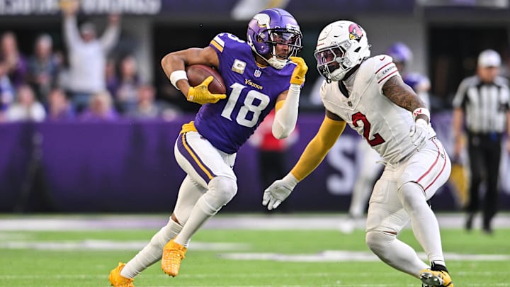 Dec 1, 2024; Minneapolis, Minnesota, USA; Minnesota Vikings wide receiver Justin Jefferson (18) gets yards after the catch as Arizona Cardinals linebacker Mack Wilson Sr. (2) looks to make the tackle during the fourth quarter at U.S. Bank Stadium.