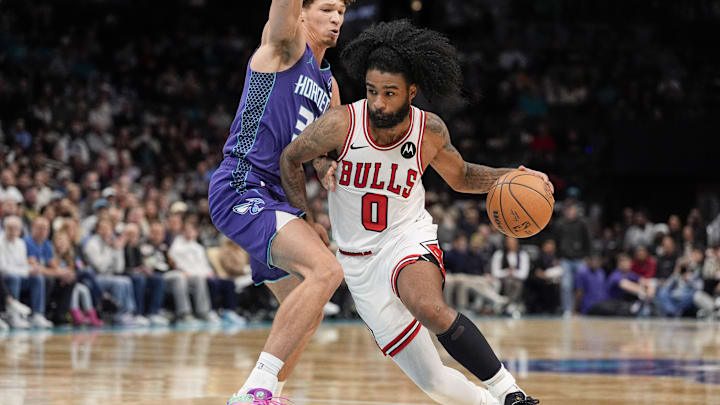 Dec 12, 2025; Charlotte, North Carolina, USA; Chicago Bulls guard Coby White (0) drives to the basket against Charlotte Hornets forward Tidjane Salaun (31) during the second half at Spectrum Center. Mandatory Credit: Jim Dedmon-Imagn Images