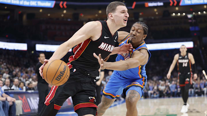 Feb 12, 2025; Oklahoma City, Oklahoma, USA; Miami Heat forward Nikola Jovic (5) drives to the basket as Oklahoma City Thunder forward Jalen Williams (8) defends during the second quarter at Paycom Center. Mandatory Credit: Alonzo Adams-Imagn Images