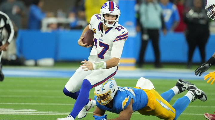 Buffalo Bills quarterback Josh Allen carries the ball against Los Angeles Chargers linebacker Tuli Tuipulotu. Buffalo Bills quarterback Josh Allen carries the ball against Los Angeles Chargers linebacker Tuli Tuipulotu.