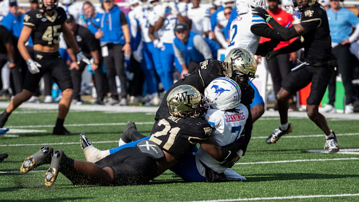 Wake Forest linebacker Aiden Hall tackles SMU quarterback Kevin Jennings. 