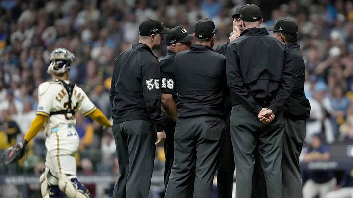 Umpires meet to discuss the fly ball hit by San Diego Padres first baseman Ty France (25) that hit a wire during the ninth inning of their National League Division Series game against the Milwaukee Brewers at American Family Field on Oct 3, 2026.