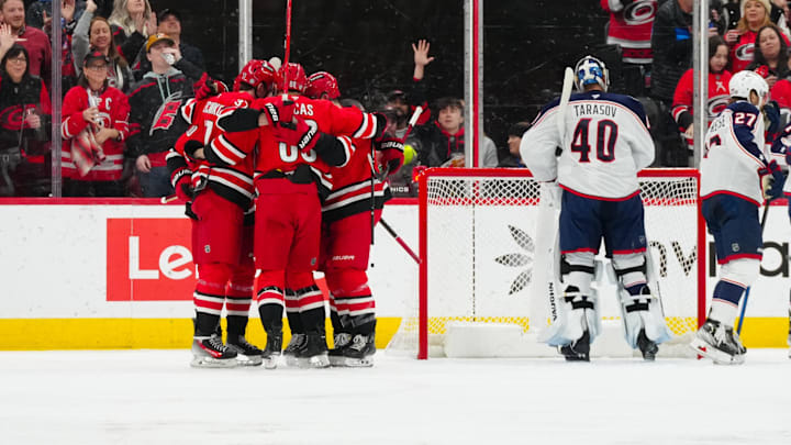 Jan 23, 2025; Raleigh, North Carolina, USA;  Carolina Hurricanes center Seth Jarvis (24) celebrates his goal with  center Martin Necas (88) and right wing Andrei Svechnikov (37) against the Columbus Blue Jackets during the second period at Lenovo Center. Mandatory Credit: James Guillory-Imagn Images