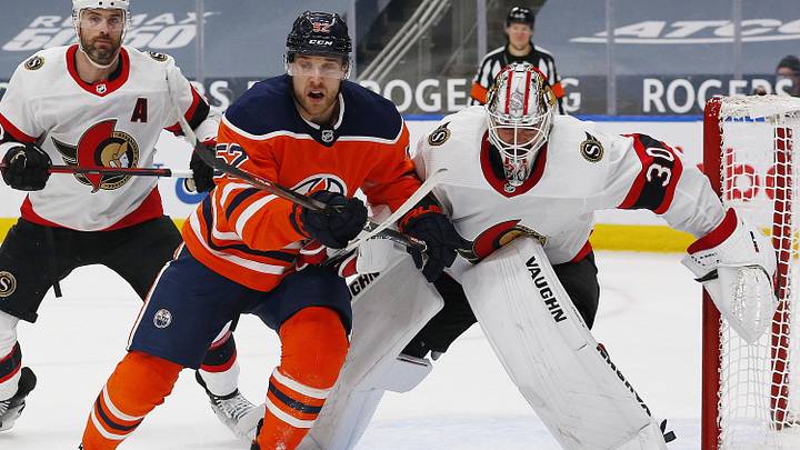 Mar 10, 2021; Edmonton, Alberta, CAN; Edmonton Oilers forward Patrick Russell (52) and Ottawa Senators goaltender Matt Murray (30) look for a loose puck during the first period at Rogers Place. Mandatory Credit: Perry Nelson-Imagn Images