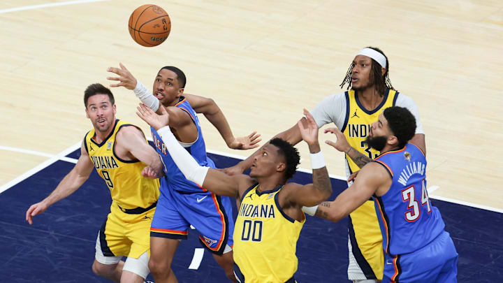 Jun 19, 2025; Indianapolis, Indiana, USA; Oklahoma City Thunder guard Aaron Wiggins (21) goes after a loose ball against Indiana Pacers guard T.J. McConnell (9) and guard Bennedict Mathurin (00) in the fourth quarter during game six of the 2025 NBA Finals at Gainbridge Fieldhouse. Mandatory Credit: Trevor Ruszkowski-Imagn Images