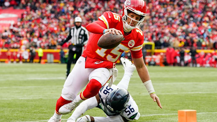 Dec 24, 2022; Kansas City, Missouri, USA; Kansas City Chiefs quarterback Patrick Mahomes (15) runs for a touchdown against Seattle Seahawks linebacker Jordyn Brooks (56) during the second half at GEHA Field at Arrowhead Stadium. Mandatory Credit: Jay Biggerstaff-Imagn Images