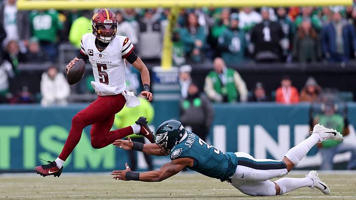 Jan 26, 2025; Philadelphia, PA, USA; Washington Commanders quarterback Jayden Daniels (5) leaps to avoid the tackle of Philadelphia Eagles linebacker Nolan Smith Jr. (3) during the first half of the NFC Championship Game at Lincoln Financial Field. Mandatory Credit: Bill Streicher-Imagn Images Jan 26, 2025; Philadelphia, PA, USA; Washington Commanders quarterback Jayden Daniels (5) leaps to avoid the tackle of Philadelphia Eagles linebacker Nolan Smith Jr. (3) during the first half of the NFC Championship Game at Lincoln Financial Field. Mandatory Credit: Bill Streicher-Imagn Images