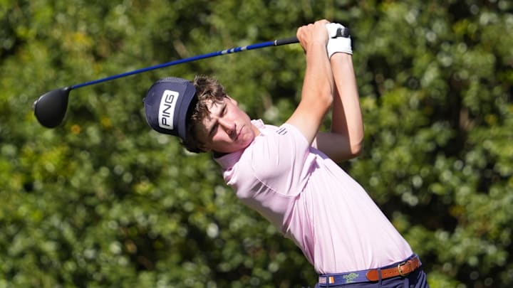 Apr 10, 2026; Augusta, Georgia, USA; Mason Howell tees off on the 11th hole as his hat slips during the second round of the Masters Tournament at Augusta National Golf Club. Mandatory Credit: Katie Goodale-Imagn Images