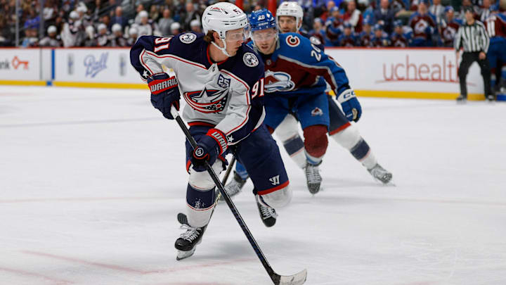 Jan 10, 2026; Denver, Colorado, USA; Columbus Blue Jackets center Kent Johnson (91) controls the puck ahead of Colorado Avalanche center Ross Colton (20) in the second period at Ball Arena. Mandatory Credit: Isaiah J. Downing-Imagn Images