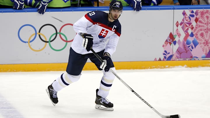 Feb 15, 2014; Sochi, RUSSIA; Slovakia defenseman Zdeno Chara (33) controls the puck against Slovenia in a men's preliminary round ice hockey game during the Sochi 2014 Olympic Winter Games at Bolshoy Ice Dome. Mandatory Credit: Winslow Townson-Imagn Images