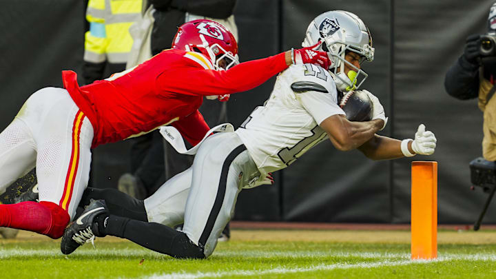 Nov 29, 2024; Kansas City, Missouri, USA; Las Vegas Raiders wide receiver Tre Tucker (11) scores a touchdown against Las Vegas Raiders place kicker Daniel Carlson (2) during the second half at GEHA Field at Arrowhead Stadium. Mandatory Credit: Jay Biggerstaff-Imagn Images