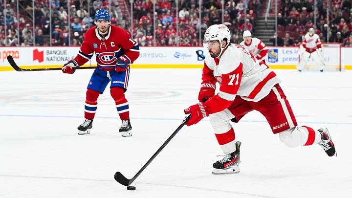 Oct 10, 2026; Montreal, Quebec, CAN; Detroit Red Wings center Dylan Larkin (71) plays the puck against Montreal Canadiens center Nick Suzuki (14) during overtime at Bell Centre. Mandatory Credit: David Kirouac-Imagn Images Oct 10, 2026; Montreal, Quebec, CAN; Detroit Red Wings center Dylan Larkin (71) plays the puck against Montreal Canadiens center Nick Suzuki (14) during overtime at Bell Centre. Mandatory Credit: David Kirouac-Imagn Images