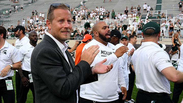 Sep 12, 2026; East Lansing, Michigan, USA;  Dan Bartholomae, MSU Vice President/Director of Athletics sings the fight song with the football team after their win over Eastern Michigan at Spartan Stadium.  Mandatory Credit: Dale Young-Imagn Images
