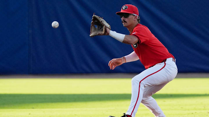 May 21, 2025; Hoover, AL, USA; Georgia shortstop Kolby Branch (9) fields a ball before throwing to first for an out during the game with Oklahoma in the second round of the SEC Baseball Tournament at the Hoover Met.