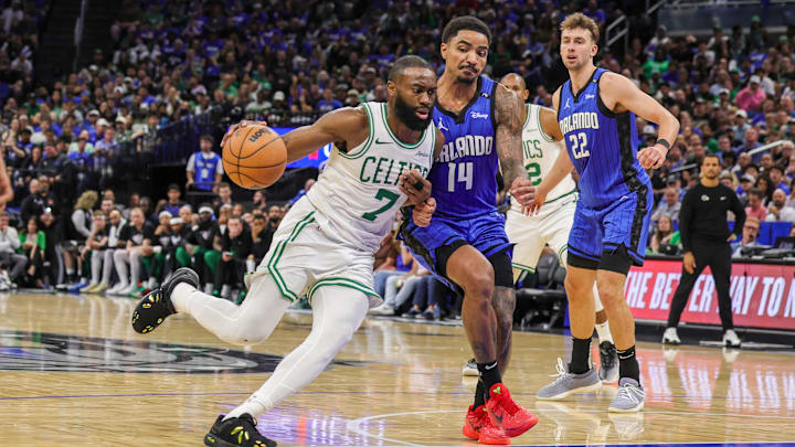 Apr 25, 2025; Orlando, Florida, USA; Boston Celtics guard Jaylen Brown (7) drives to the basket against Orlando Magic guard Gary Harris (14) during the second half of game three of first round for the 2024 NBA Playoffs at Kia Center. Mandatory Credit: Mike Watters-Imagn Images