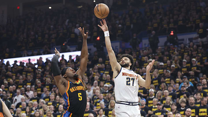 May 7, 2025; Oklahoma City, Oklahoma, USA; Denver Nuggets guard Jamal Murray (27) shoots as Oklahoma City Thunder guard Luguentz Dort (5) defends in the first quarter during game two of the second round for the 2025 NBA Playoffs at Paycom Center. Mandatory Credit: Alonzo Adams-Imagn Images