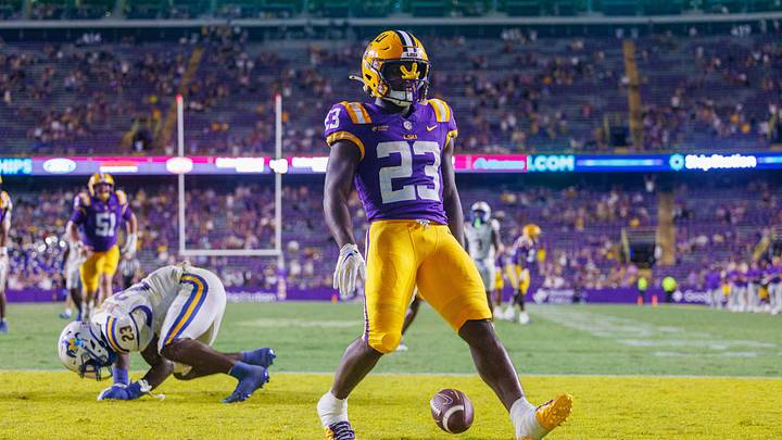 Oct 3, 2026; Baton Rouge, Louisiana, USA; LSU Tigers running back Stacy Gage (23) rushes for a touchdown against McNeese Cowboys defensive end RJ Staten (23) during the second half at Tiger Stadium. Mandatory Credit: Stephen Lew-Imagn Images Oct 3, 2026; Baton Rouge, Louisiana, USA; LSU Tigers running back Stacy Gage (23) rushes for a touchdown against McNeese Cowboys defensive end RJ Staten (23) during the second half at Tiger Stadium. Mandatory Credit: Stephen Lew-Imagn Images