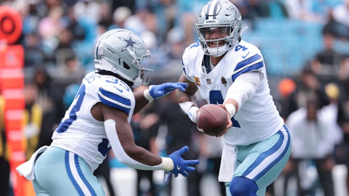 Dallas Cowboys QB Dak Prescott hands the ball off to RB Javonte Williams against the Carolina Panthers.