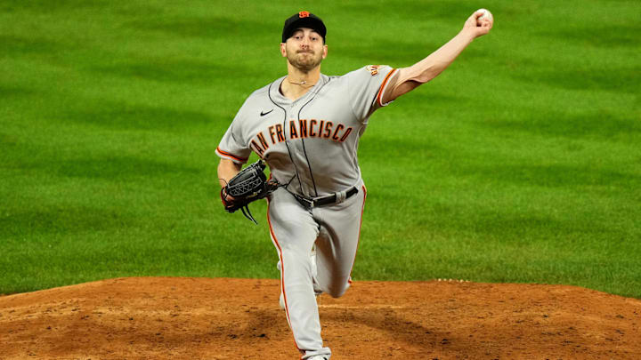 Sep 21, 2022; Denver, Colorado, USA; San Francisco Giants starting pitcher Thomas Szapucki (61) pitches in the ninth inning against the Colorado Rockies at Coors Field. Ron Chenoy-Imagn Images