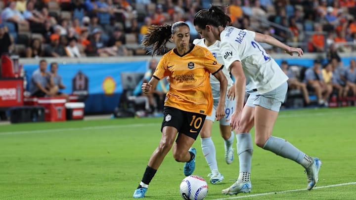 Houston Dash midfielder Andressa Alves (10) plays the ball defended by Seattle Reign FC defender Phoebe McClernon (21)  