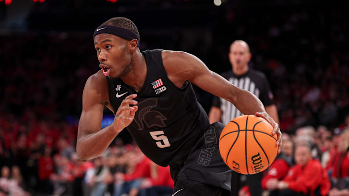 Jan 25, 2025; New York, New York, USA; Michigan State Spartans guard Tre Holloman (5) drives to the basket against the Rutgers Scarlet Knights during the second half at Madison Square Garden. Mandatory Credit: Vincent Carchietta-Imagn Images