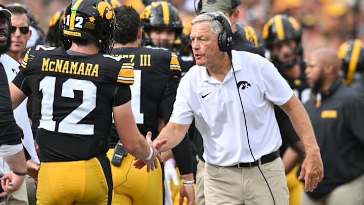Sep 14, 2024; Iowa City, Iowa, USA; Iowa Hawkeyes head coach Kirk Ferentz reacts with quarterback Cade McNamara (12) after a touchdown against the Troy Trojans during the second quarter at Kinnick Stadium. Mandatory Credit: Jeffrey Becker-Imagn Images