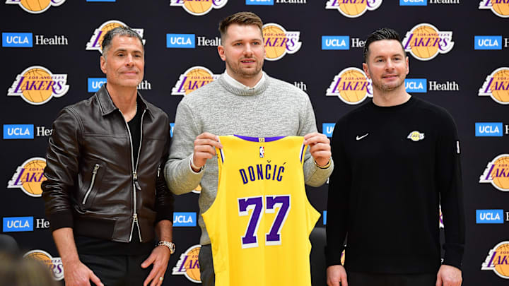 Feb 4, 2025; El Segundo, CA, USA; Los Angeles Lakers guard Luka Doncic poses for photos with general manager Rob Pelinka and head coach JJ Redick at UCLA Health Training Center. Mandatory Credit: Gary A. Vasquez-Imagn Images